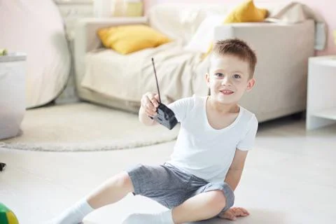 A boy playing with a car remote Stock Photos