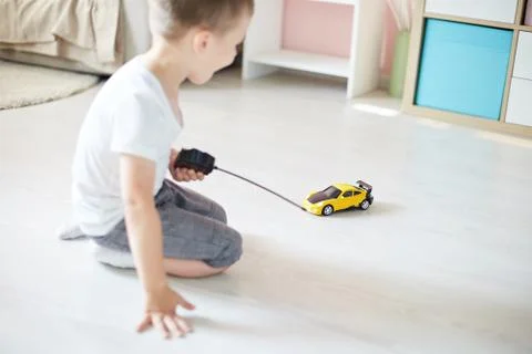 A boy playing with a car remote Stock Photos