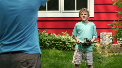 Boy playing catch in the backyard Video stock 6109796