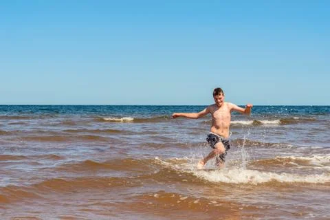 Boy playing on the Cavendish beach Stock Photos