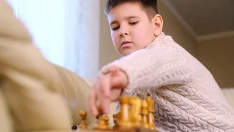 A boy playing chess with himself Video stock 150384853