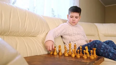 A boy playing chess with himself Video stock 150384855