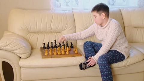 A boy playing chess with himself Video stock 150384858
