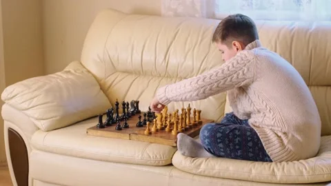 A boy playing chess with himself Video stock 150384859