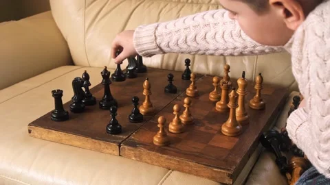 A boy playing chess with himself Video stock 150384870