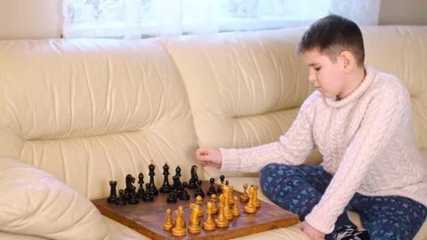 A boy playing chess with himself Video stock 150384879