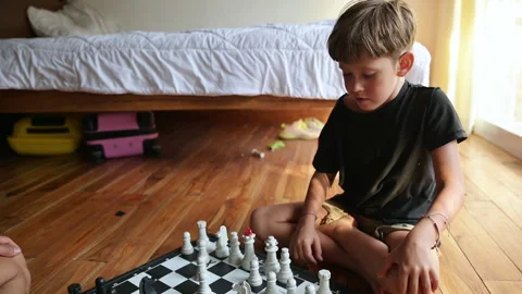 A boy playing chess at home Stock Footage 244922470