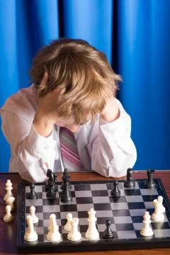 Boy playing chess Stock Photos