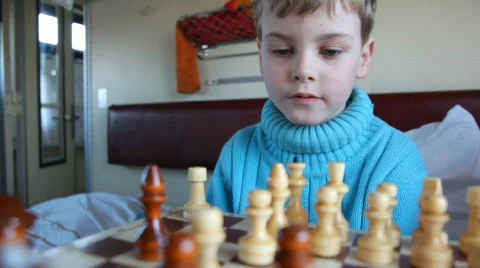 Boy, playing chess on a train Video stock 501621