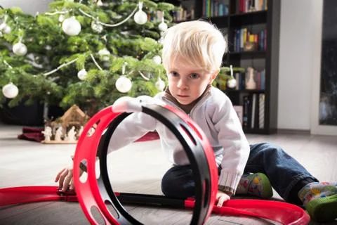 Boy playing with Christmas present Stock Photos