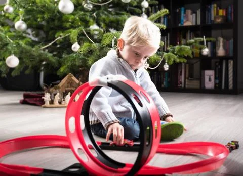 Boy playing with Christmas present Stock Photos