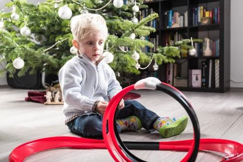 Boy playing with Christmas present Stock Photos