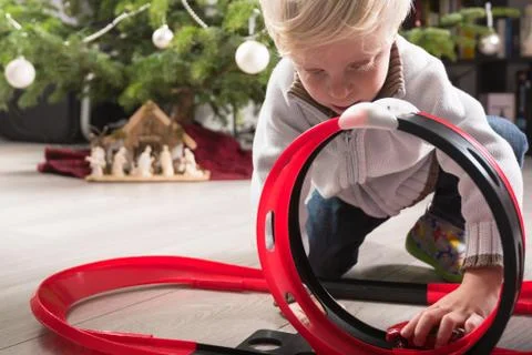 Boy playing with Christmas present Stock Photos
