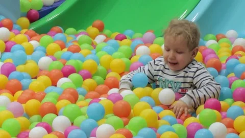 Boy playing with colored balls Video stock 71834339