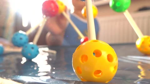 Boy playing with colorful plastic construction set. Balls and pins. 4K close up Stock Footage