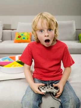 Boy playing computer game Stock Photos