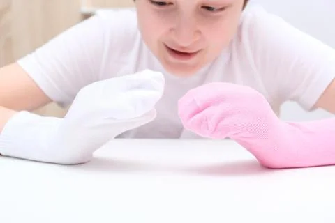 A boy playing creative handmade hand puppets made of socks, home theatre Stock Photos