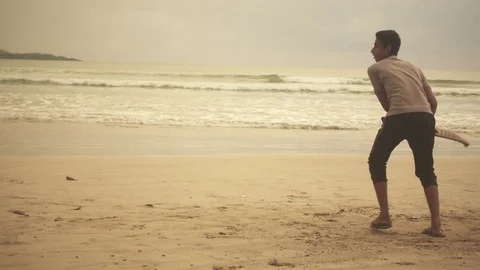 A boy playing cricket in a beach of sri lanka Stock Footage 82314069
