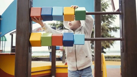 Boy playing cubes on the playground. Stock Footage 91052822