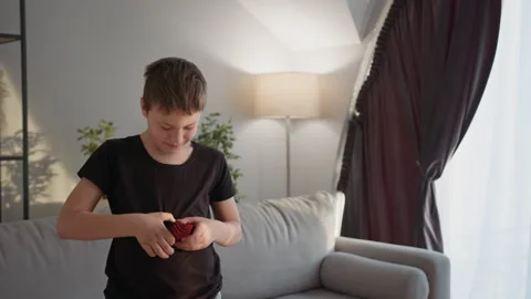 Boy Playing Darts Indoors. Thoughtful child casual game focused home leisure Stock Footage 335478767