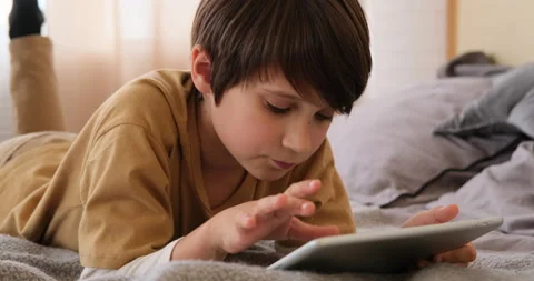 Boy playing on digital tablet Stock Footage 145236162