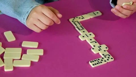 Boy playing domino while spending time at home. Children are play board games. Stock Footage 133043368