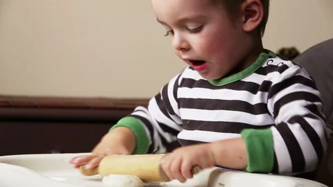 Boy playing with dough Stock Footage 100467920