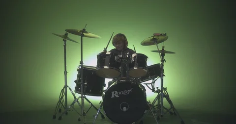 Boy playing drums in slow motion Stock Footage 99990496