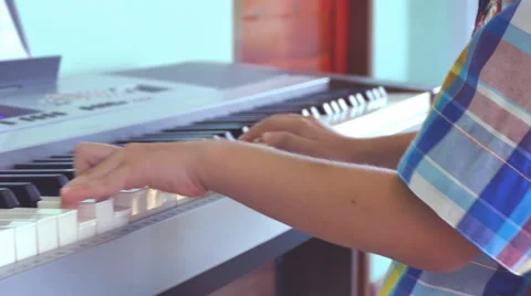 Boy playing on electone Stock Footage 53251340