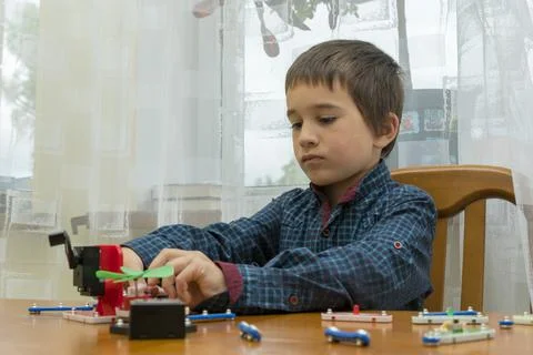 The boy playing an electric constructor. The child is played by intellectual Stock Photos