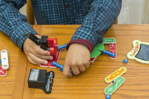 The boy playing an electric constructor. The child is played by intellectual  Stock Photos