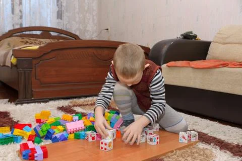 Boy playing on the floor Stock Photos
