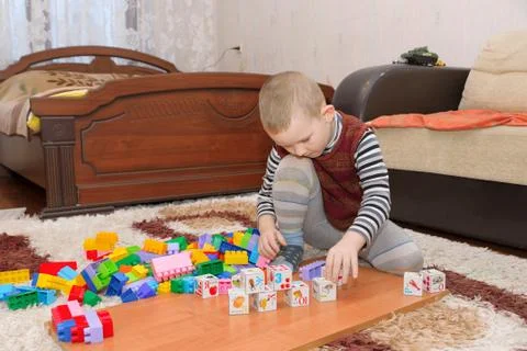 Boy playing on the floor Stock Photos