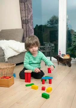 Boy playing on the flooring Stock Photos