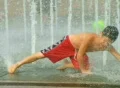 Boy Playing in Fountain Footage