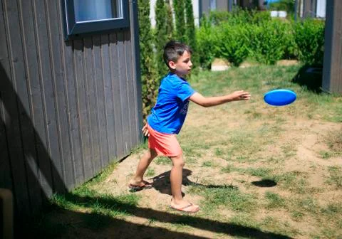 Boy playing with a frizbee Stock Photos