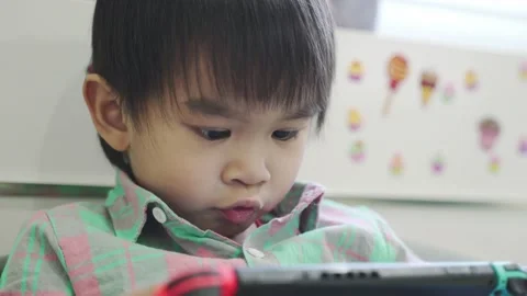 Boy Playing game on bed 스톡 동영상 192444171