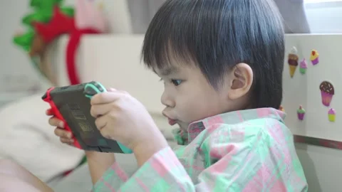 Boy Playing game on bed 스톡 동영상 192444231