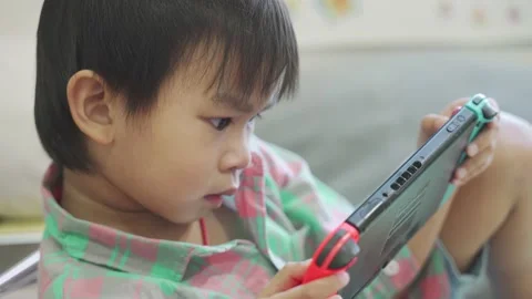 Boy Playing game on bed 스톡 동영상 192444260