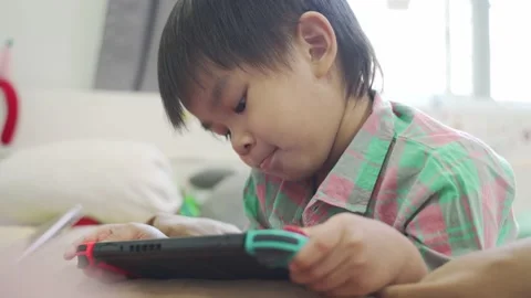 Boy Playing game on bed 스톡 동영상 192444444