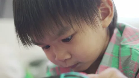 Boy Playing game on bed 스톡 동영상 192444578