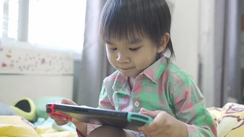 Boy Playing game on bed 스톡 동영상 192444590