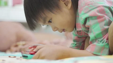 Boy Playing game on bed 스톡 동영상 192444617