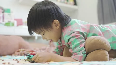 Boy Playing game on bed 스톡 동영상 192444622