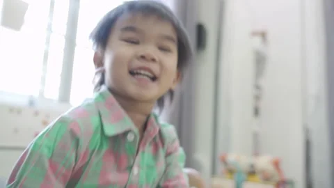 Boy Playing game on bed 스톡 동영상 192444684