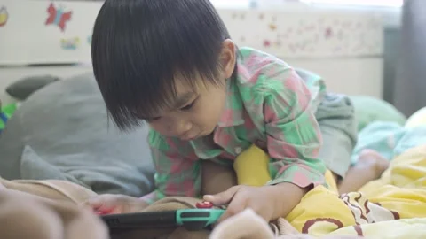 Boy Playing game on bed 스톡 동영상 192444687