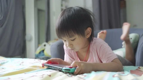 Boy Playing game on bed 스톡 동영상 196005070