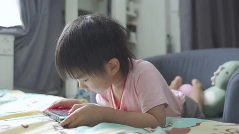 Boy Playing game on bed 스톡 동영상 196005100