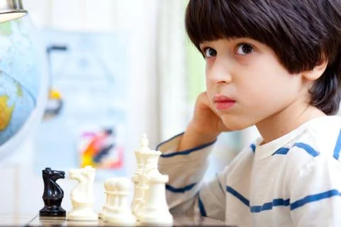 Boy playing a game of chess Stock Photos