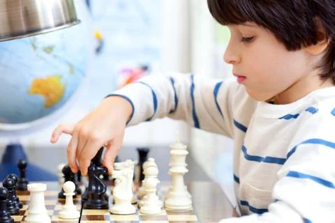 Boy playing a game of chess Stock Photos